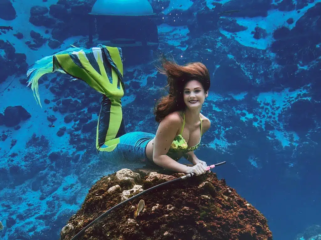 A Mermaid at Weeki Wachee Springs State Park A Mermaid performer at Weeki Wachee Springs State Park smiles and poses underwater.