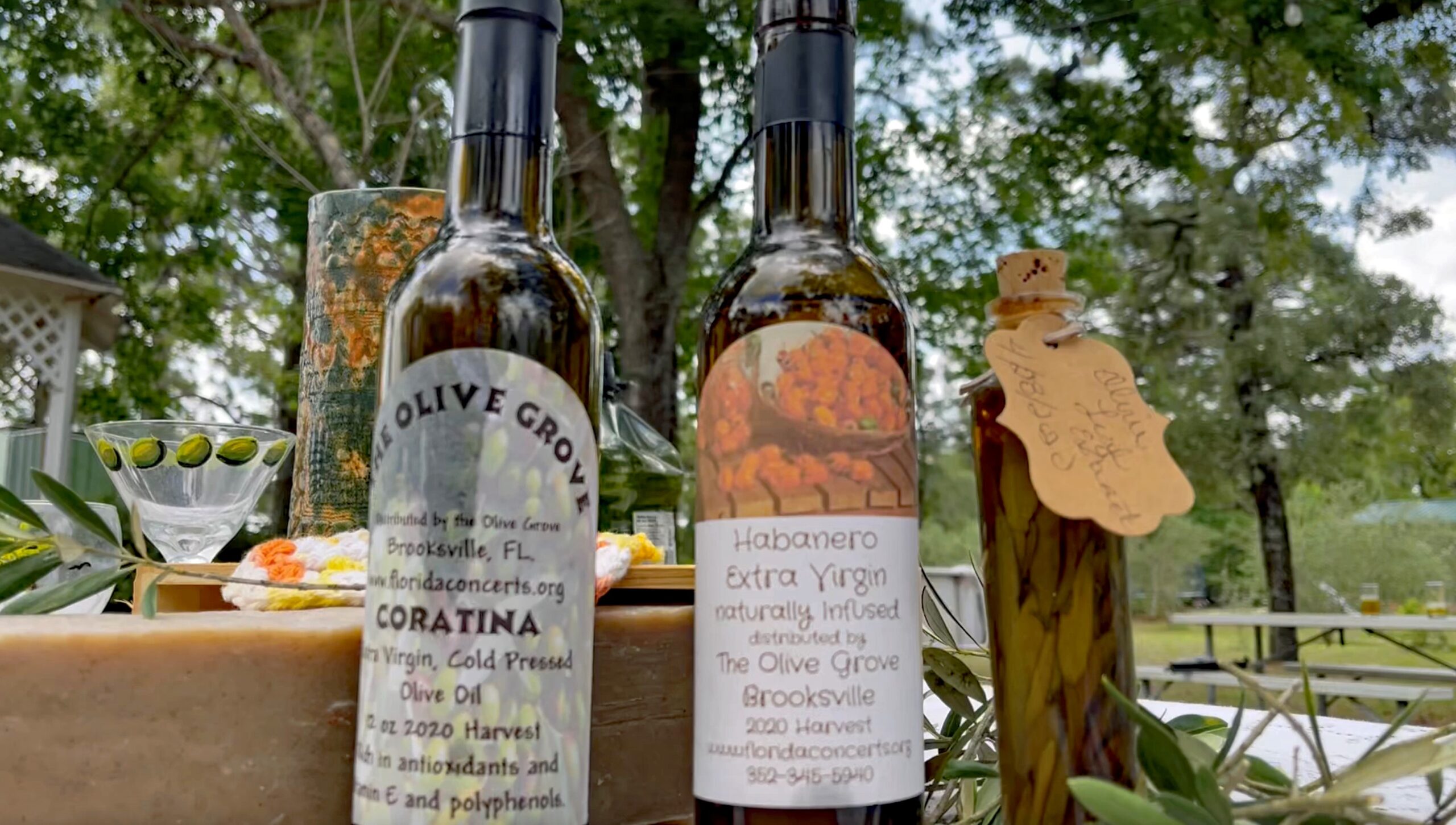 A pair of Olive Oil Bottles on an outdoor table at The Olive Grove