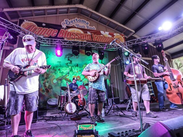 photo of music group on stage. credit Brian Hensley Photography