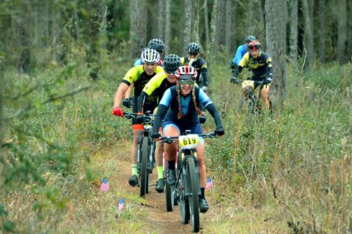 Group of BMX riders on trail in the woods of Hernando County.